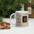 A Cat's Passport Mug – white glossy ceramic 11oz mug with travel-stamp cat passport design, handle on left